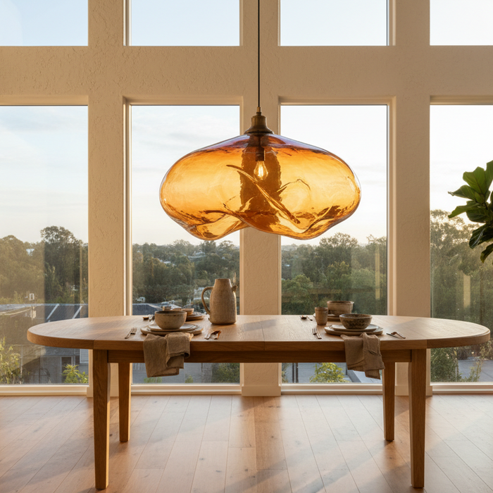 Statement lass pendant light over table in apartment