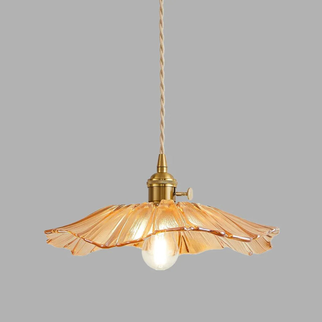 Amber pendant light with a glass shade on a grey background