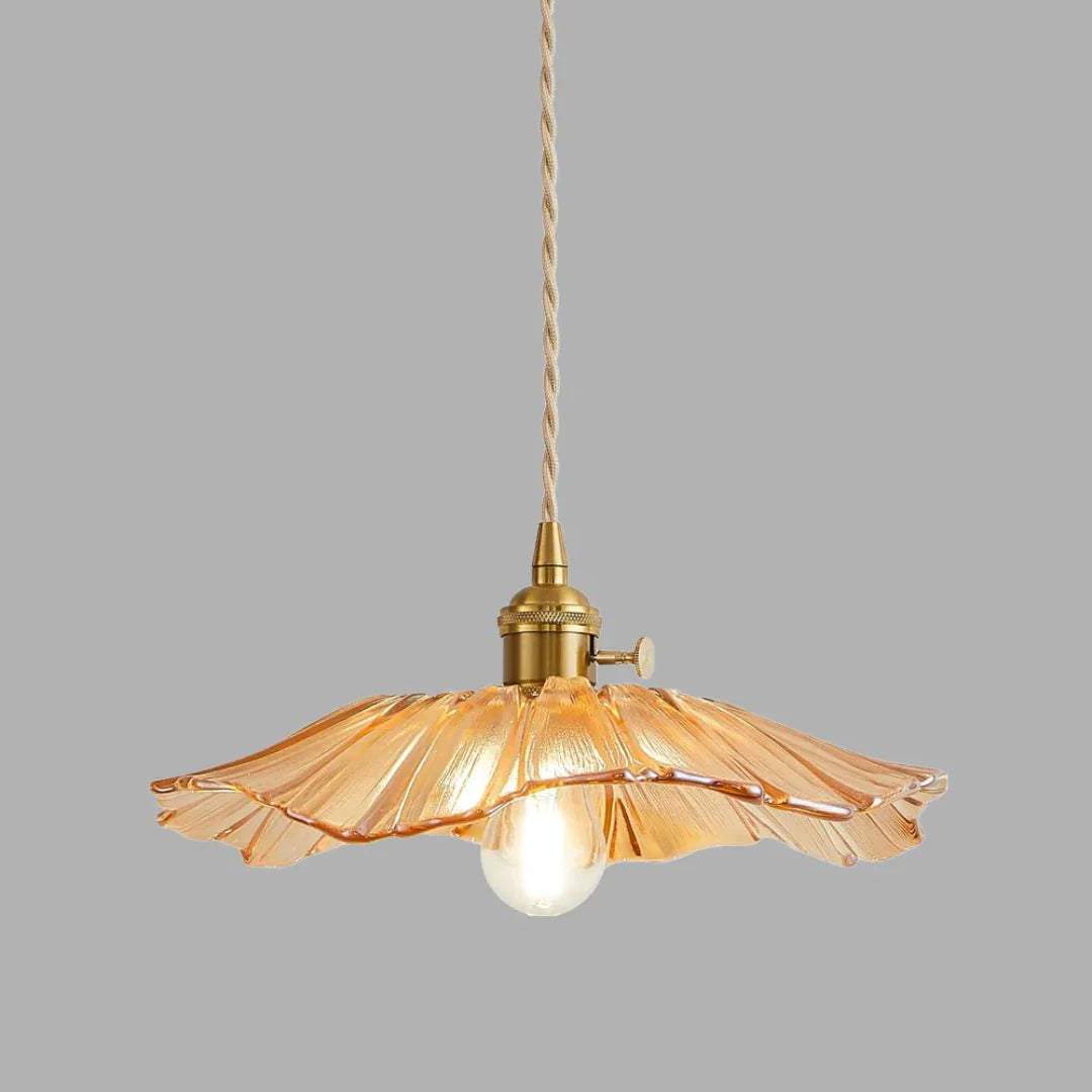 Amber pendant light with a glass shade on a grey background