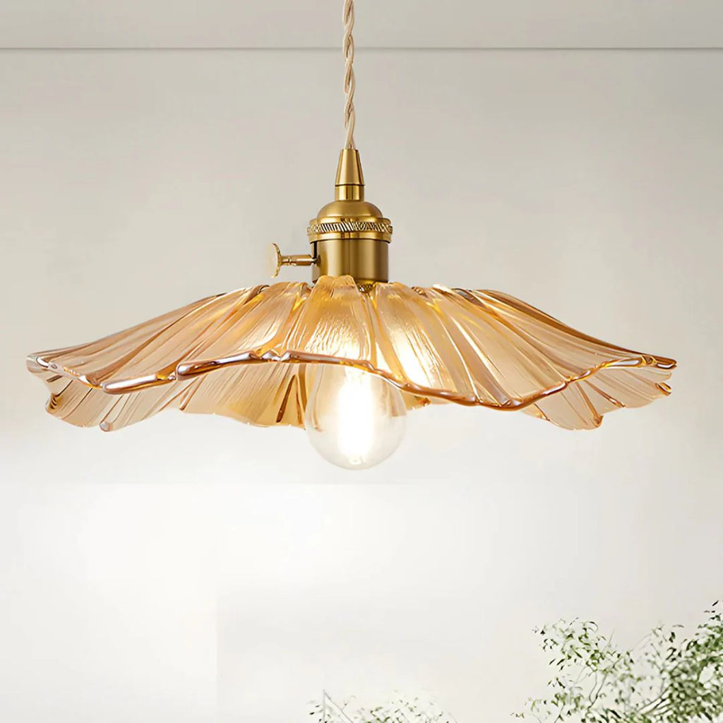 Vintage-style pendant light with amber glass shade on a white background