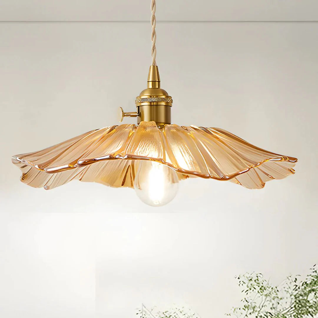 Vintage-style pendant light with amber glass shade on a white background