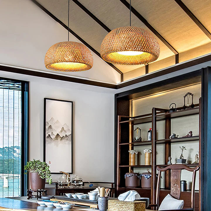 Modern interior with bamboo pendant lights, wooden furniture, and decorative items.