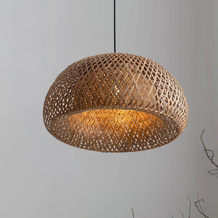 Woven bamboo wooden pendant light against a grey background