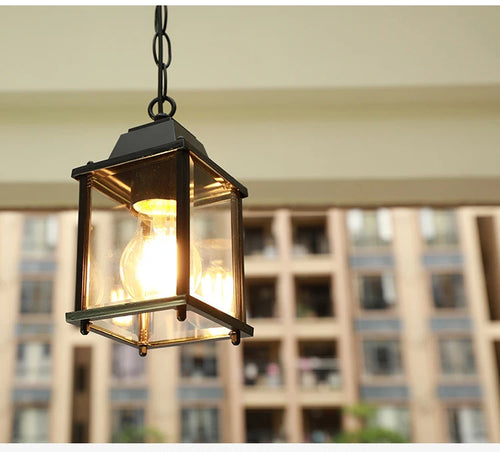 Decorative hanging light fixture with a blurred building background