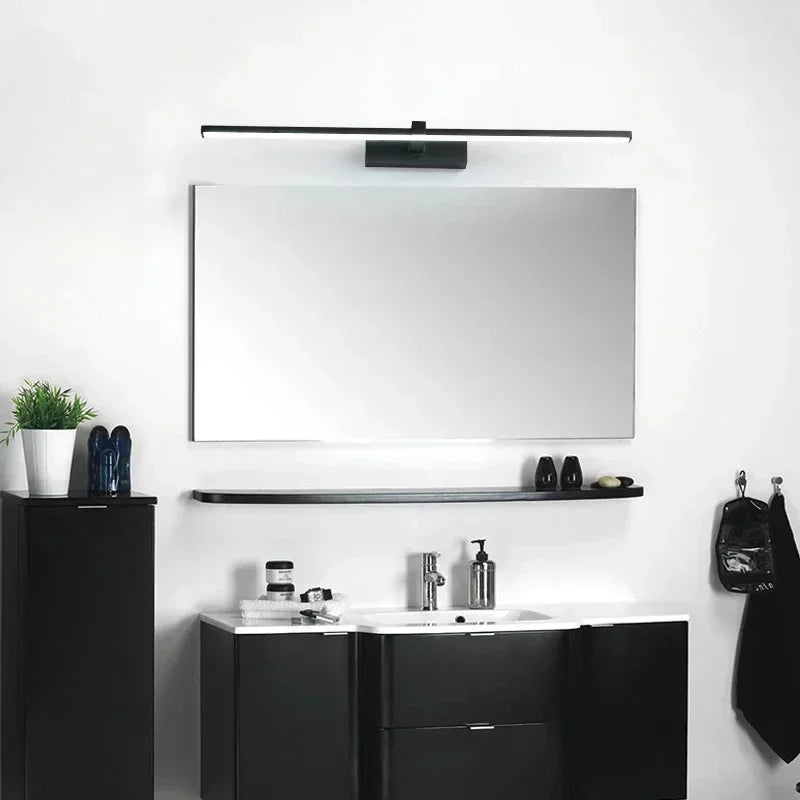 Bathroom setup with black vanity, white countertop, and mirror above.