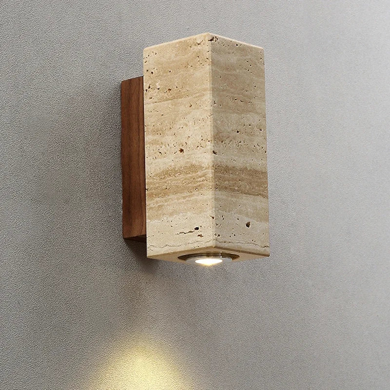 Square stone wall light fixture on a grey wall