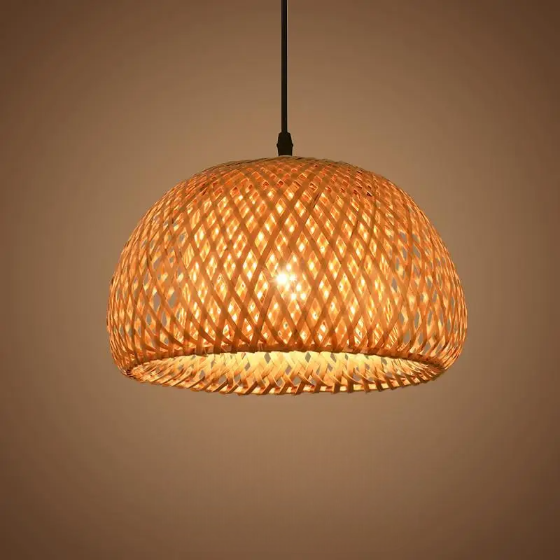 Woven bamboo pendant light with a warm glow on a beige background