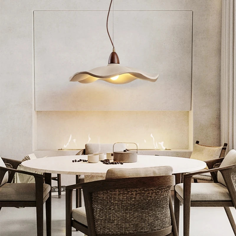 Dining room with a modern pendant light fixture over a round table.