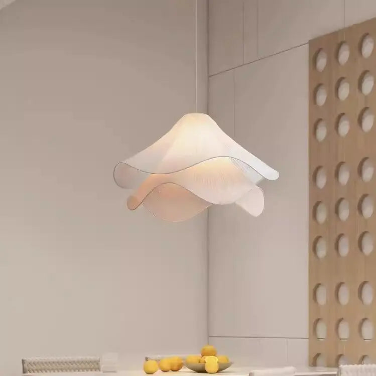 Modern pendant light hanging in a kitchen with a neutral color scheme