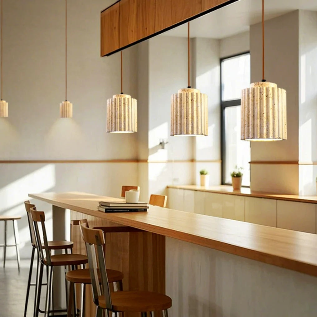Modern interior with wooden counter, chairs, and pendant lights.