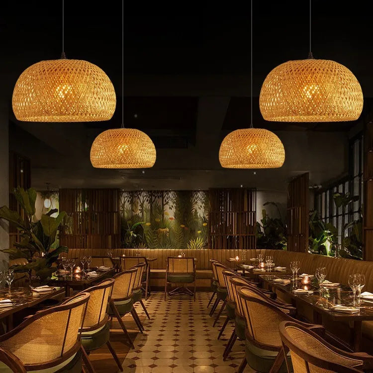 Dining room with bamboo pendant lights and wooden chairs.