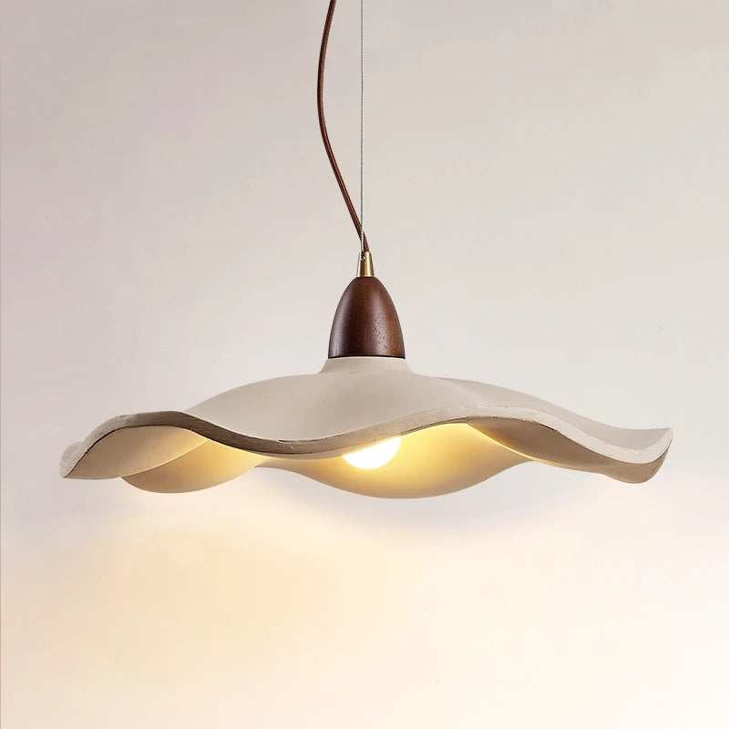 Modern pendant light with wavy design on a neutral background