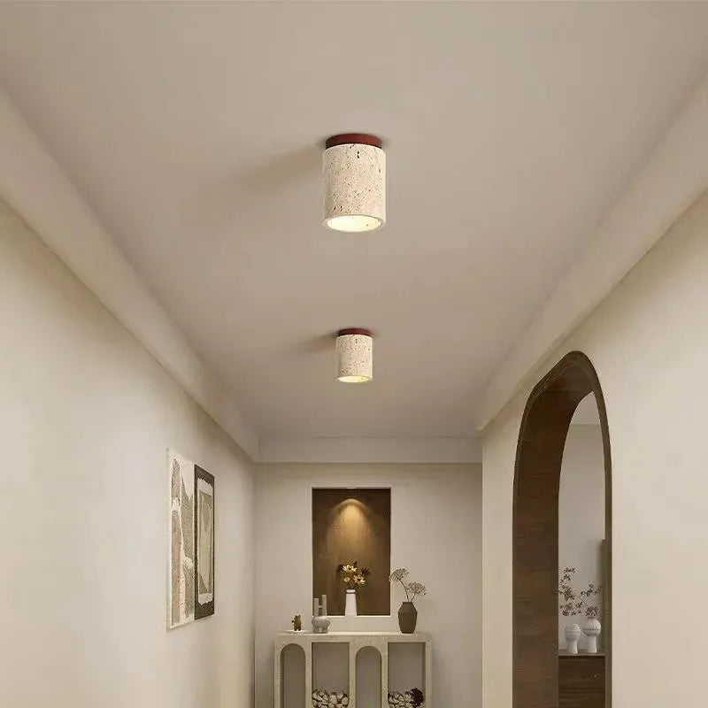 Modern hallway with travertine ceiling lights and decorative elements