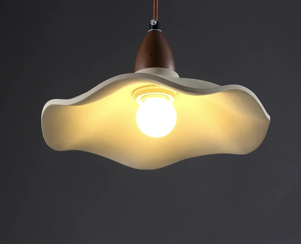 Modern pendant light with a unique shade on a dark background