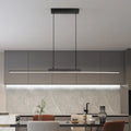 Modern kitchen with grey cabinets, pendant light, and marble backsplash.
