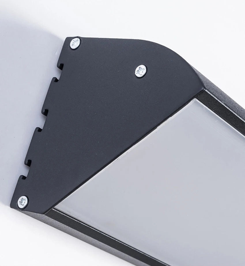 Up close shot of the side of the outdoor motion sensor light against a white background