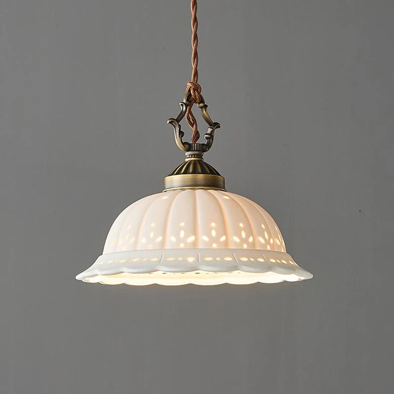 Vintage-style pendant light with decorative glass shade on a grey background
