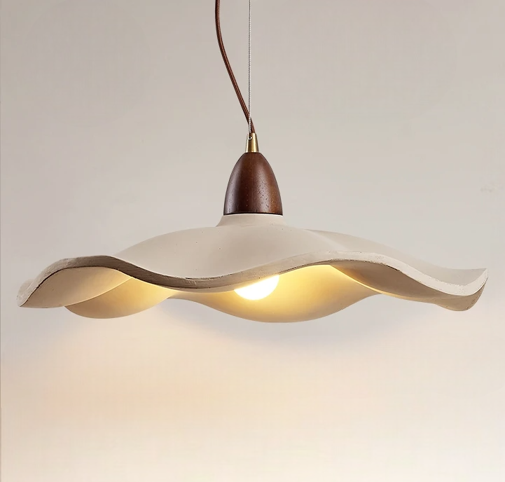 Modern pendant light with wavy design on a neutral background