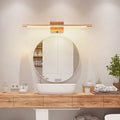 Modern bathroom vanity with round mirror, wooden cabinet, and decorative items.