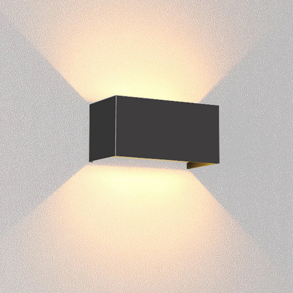Black wall-mounted outdoor light fixture on a grey background