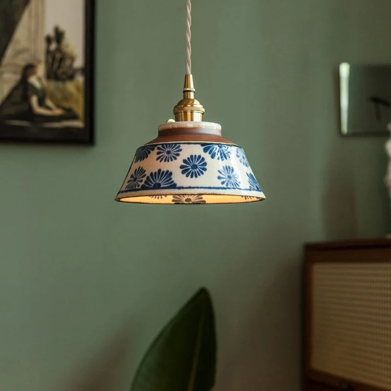 Pendant light with floral pattern on a green wall