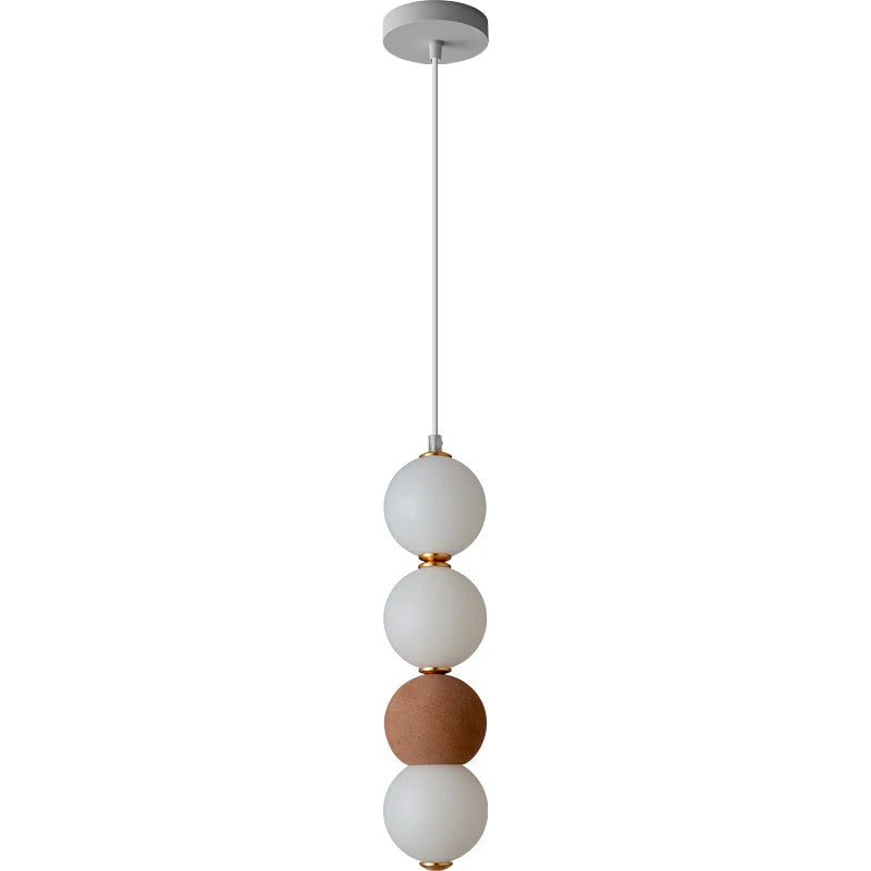 Pendant light with three spherical shades on a white background