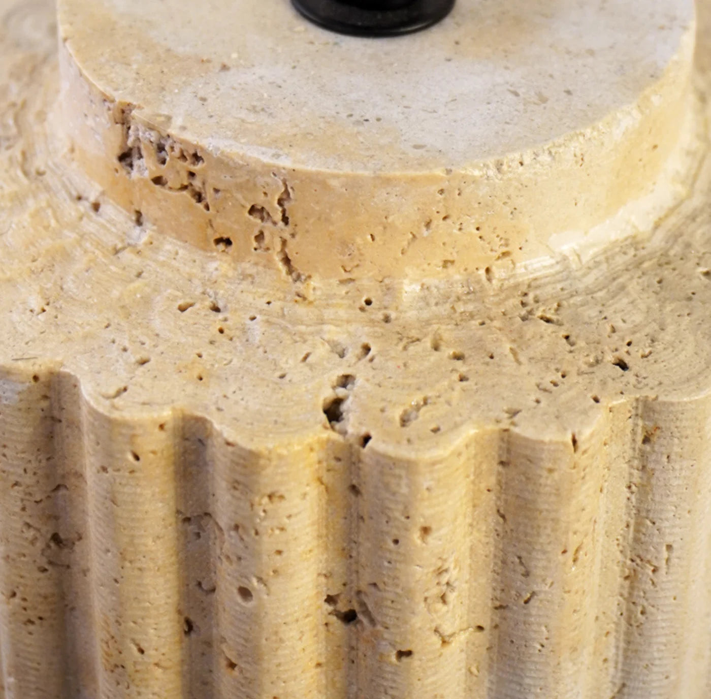Close-up of a cylindrical stone object with textured surface