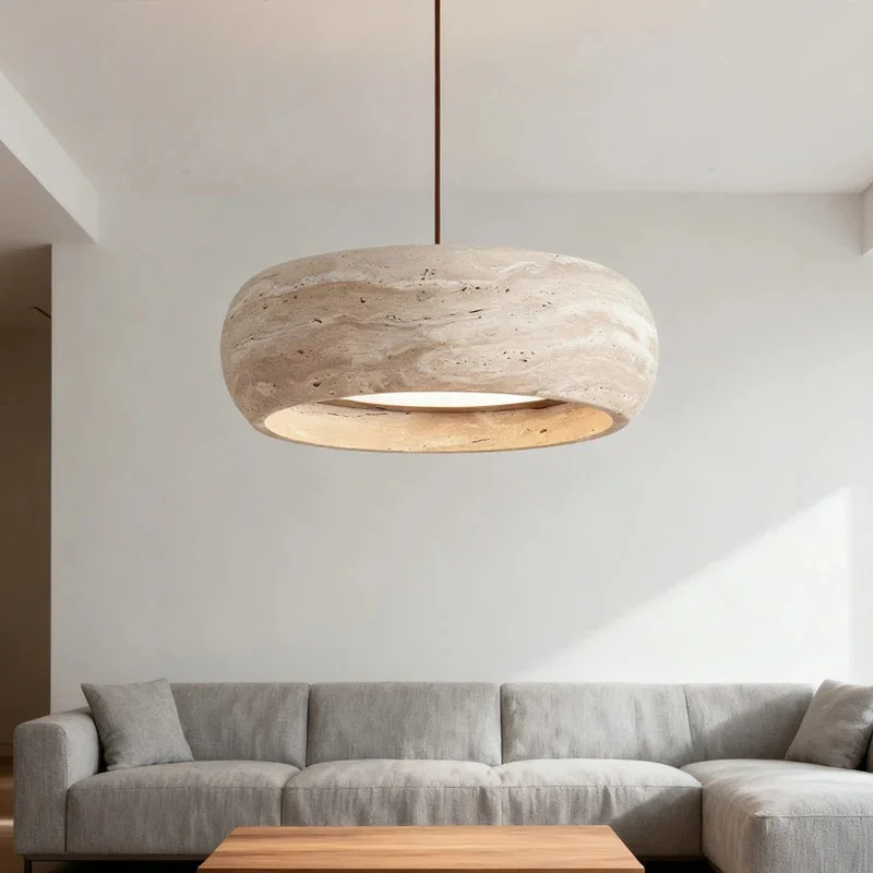 Ceiling light fixture hanging above a sofa in a modern living room.