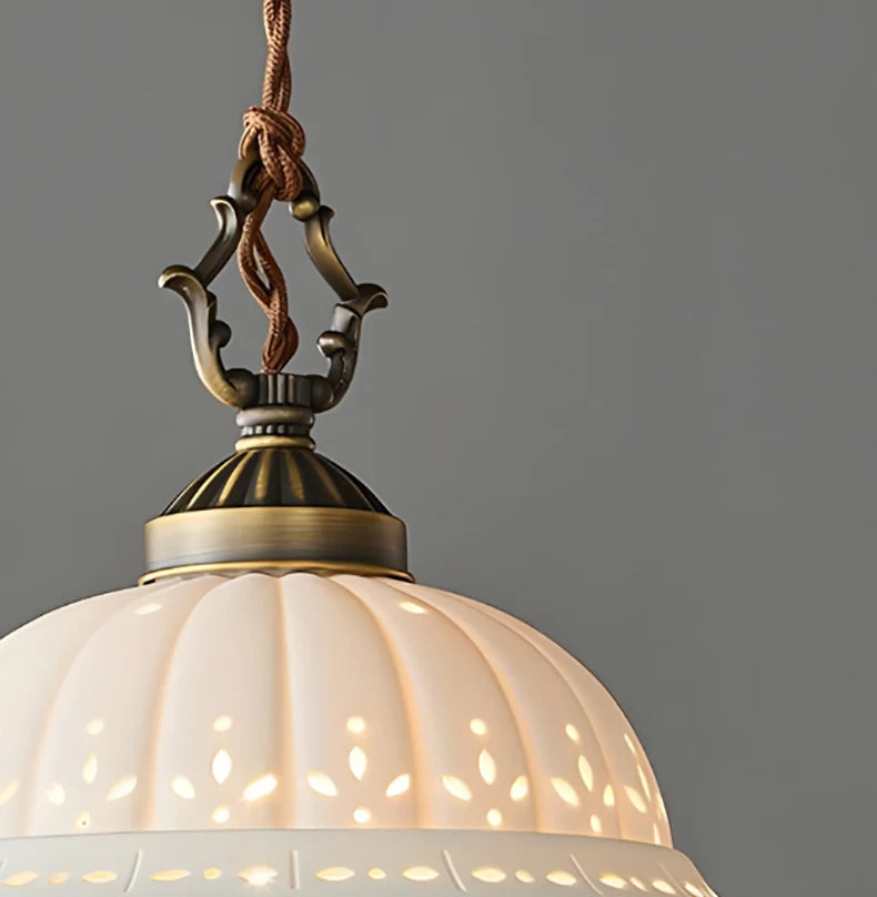 Vintage-style pendant light with decorative metal fixture against a grey background