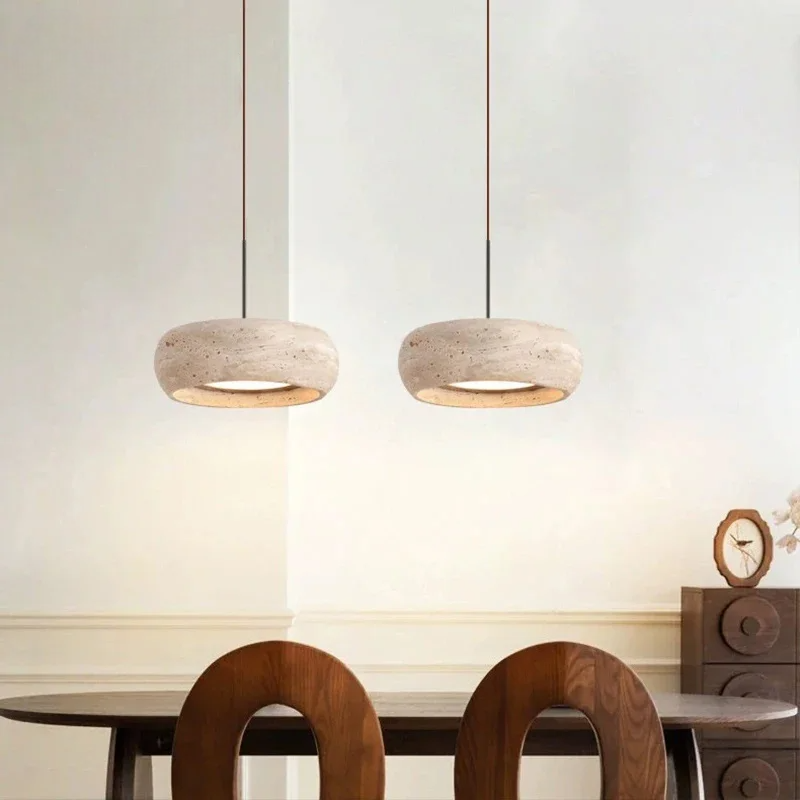 Two travertine ceiling pendant lights above kitchen table