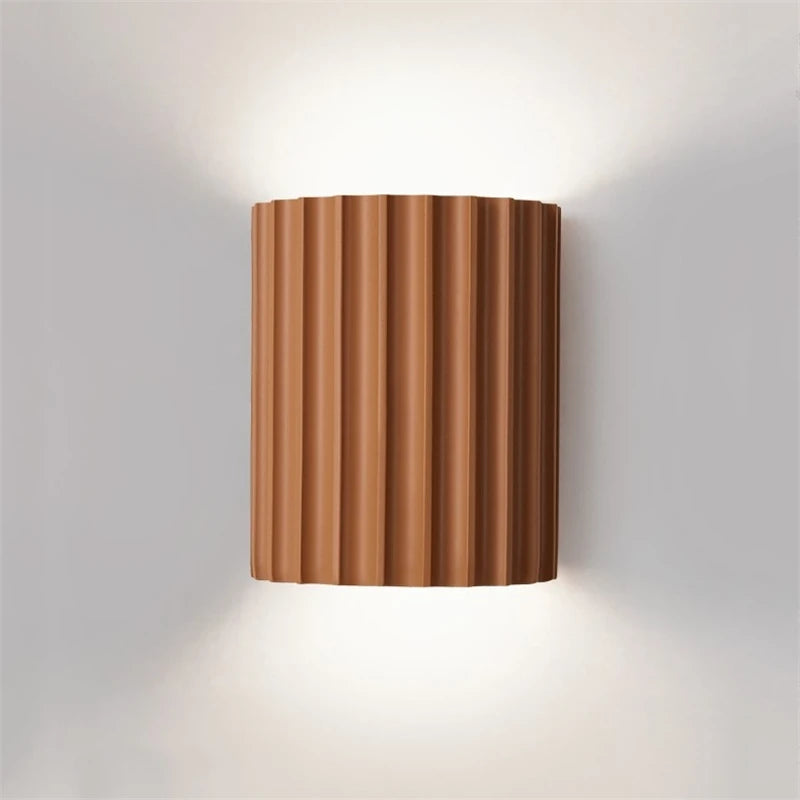 Orange wall-mounted light fixture on a grey background