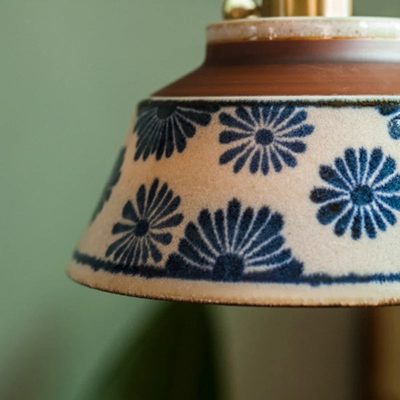 Close-up of a lampshade with blue floral pattern on a beige background