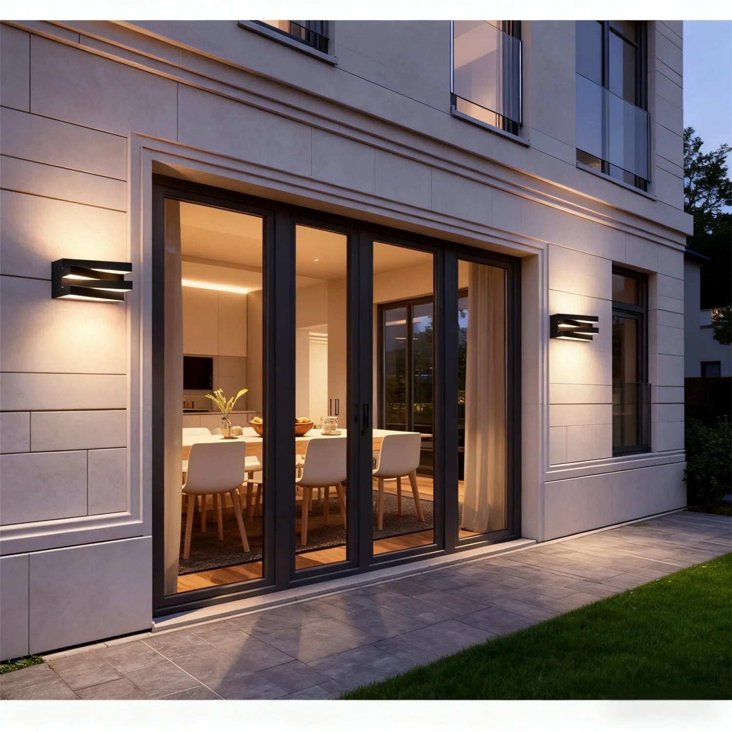 Modern house exterior with black wall lights illuminating