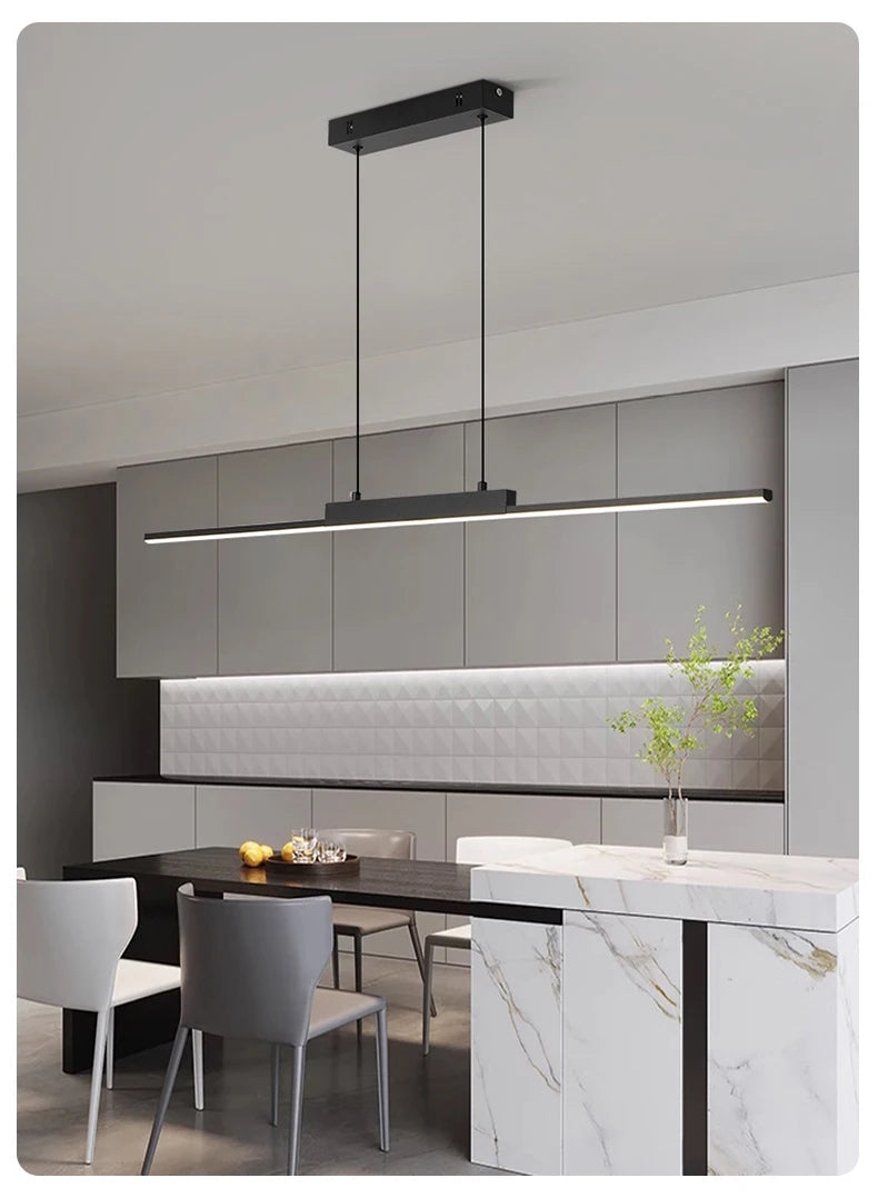 Modern kitchen illuminated by modern linear pendant light