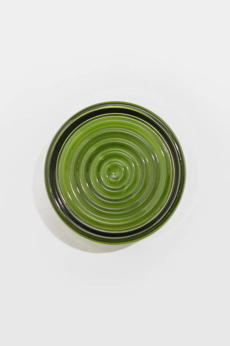 Emerald glass light with concentric circles on a white background