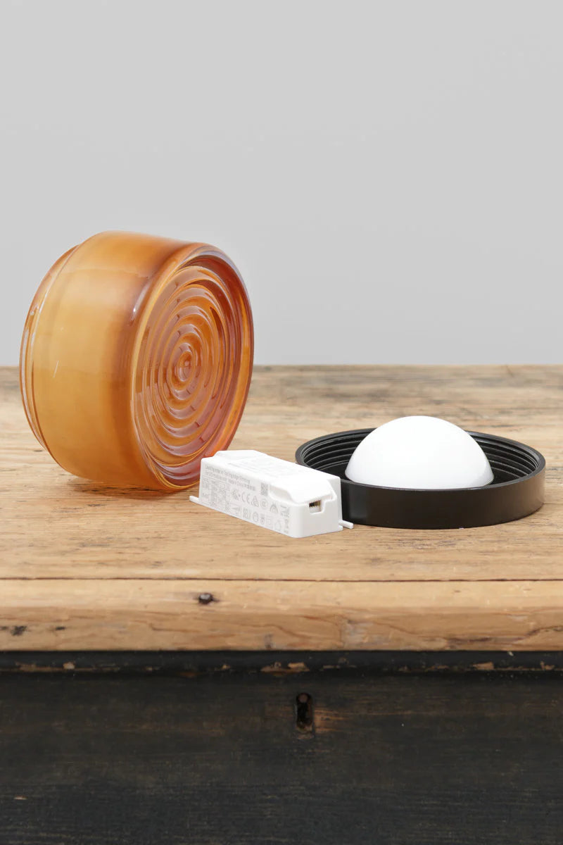 Amber variant circular wall sconce opened up to reveal its contents