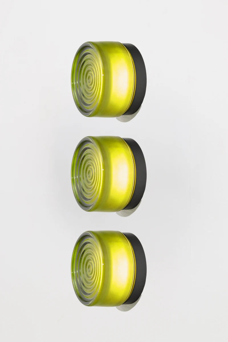 Three green circular lights with black borders on a white background
