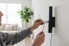 Person working on electrical wiring in a home setting