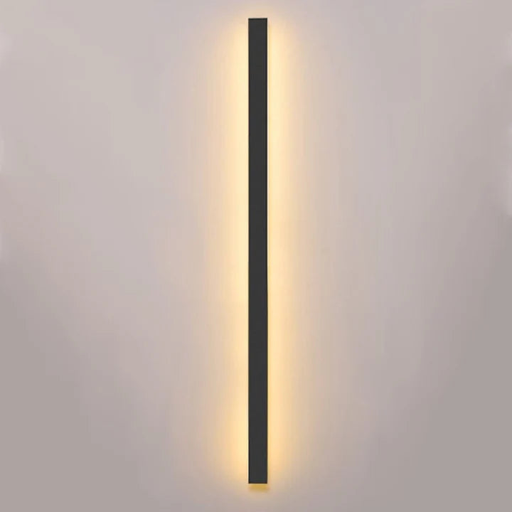 Outdoor wall light illuminating a warm light against white background